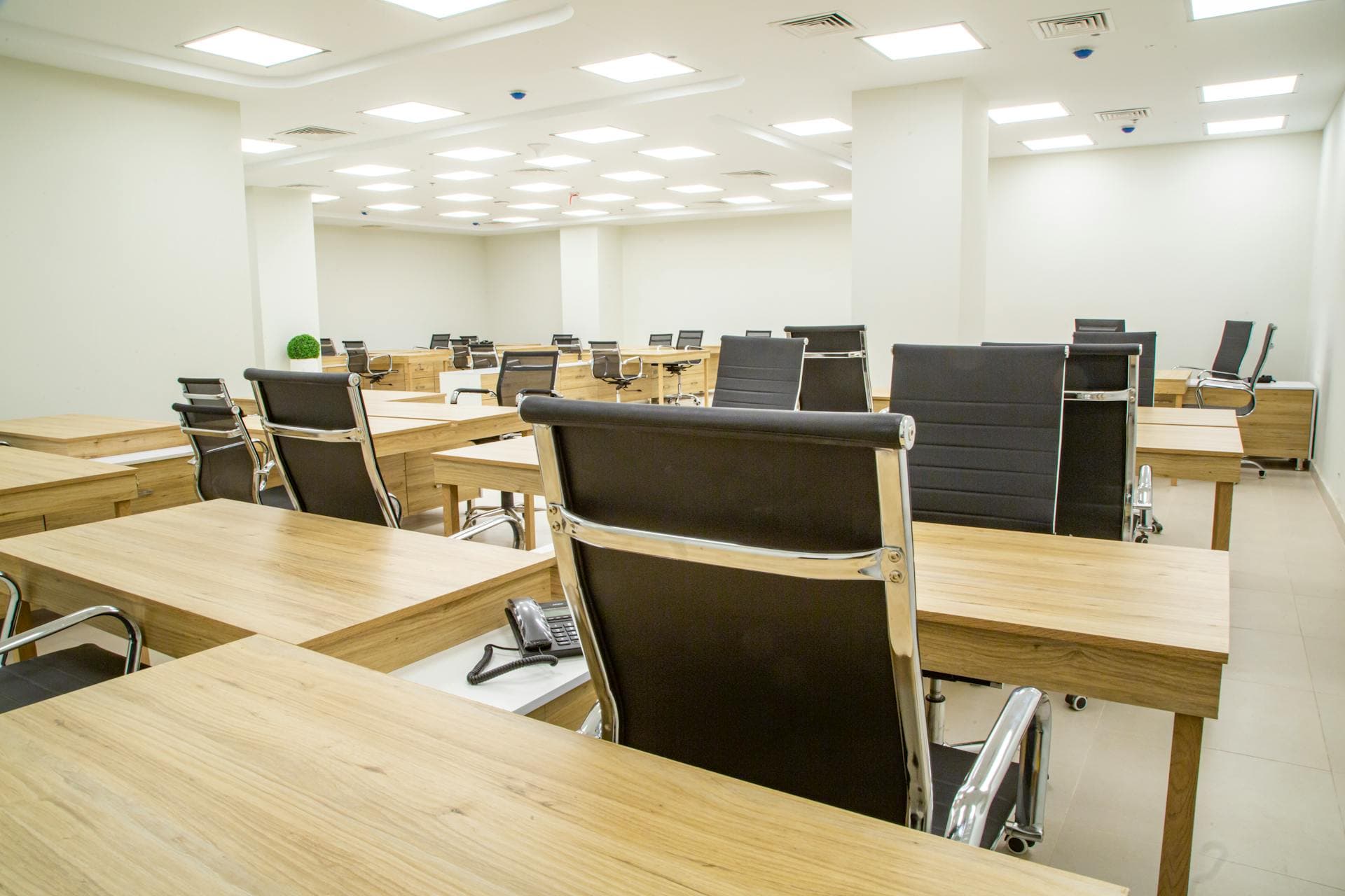 Office with solid wooden desks and chairs in daily use