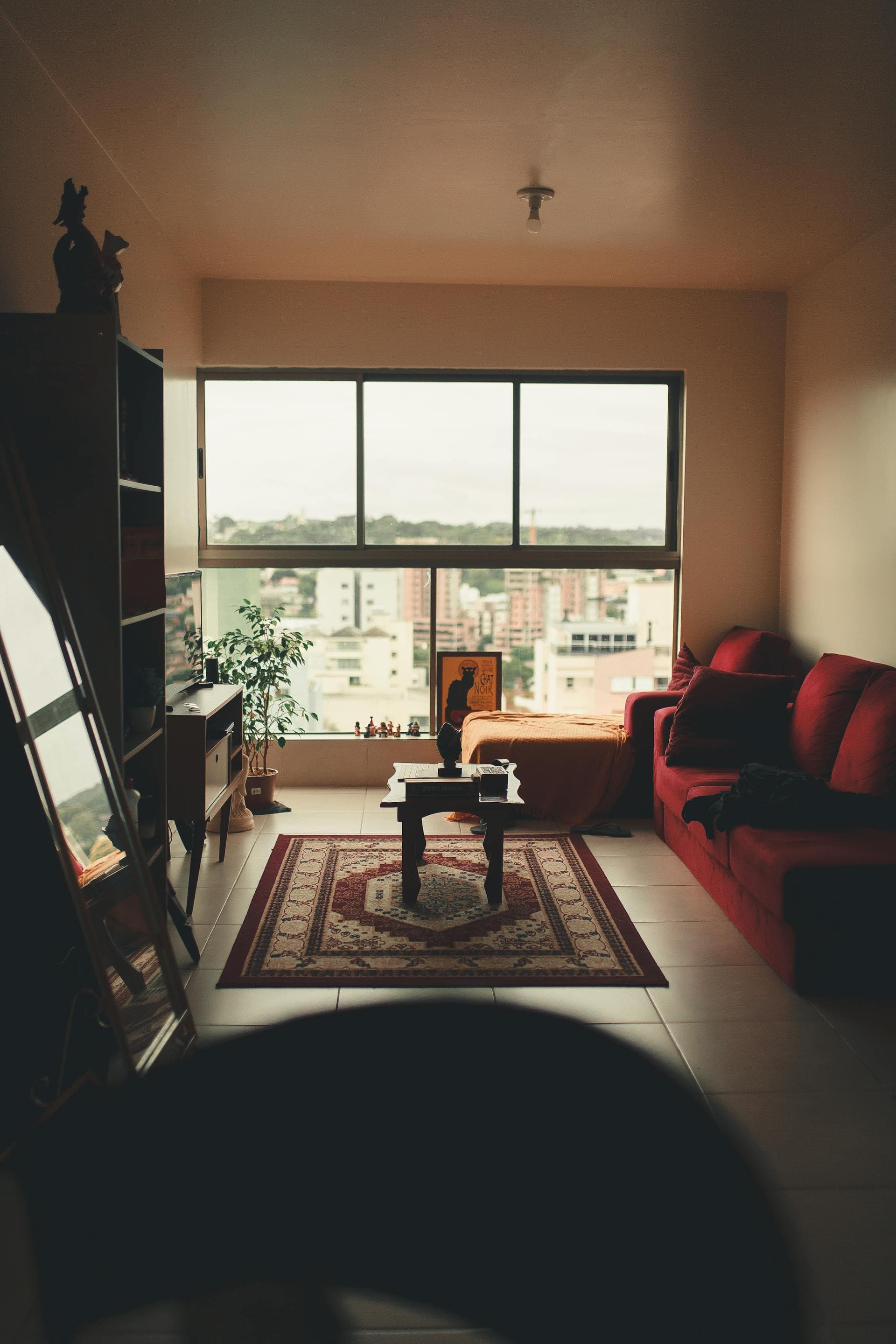 Apartment living room with solid wooden furniture and natural daylight